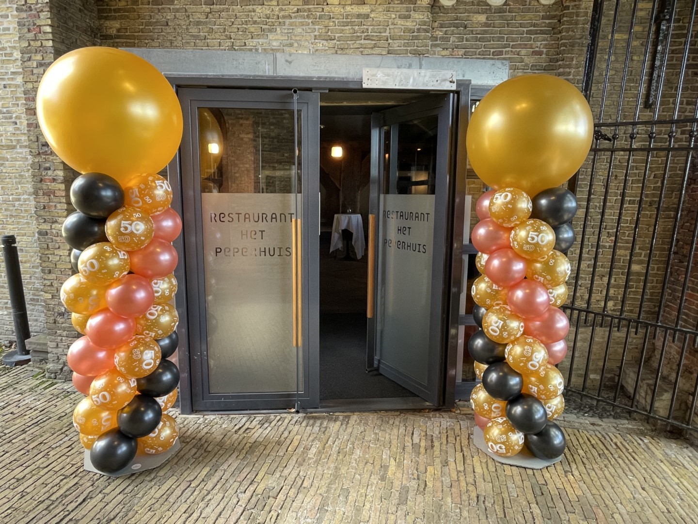 Ballonnenpilaren met bedrukte ballonnen in de stam.